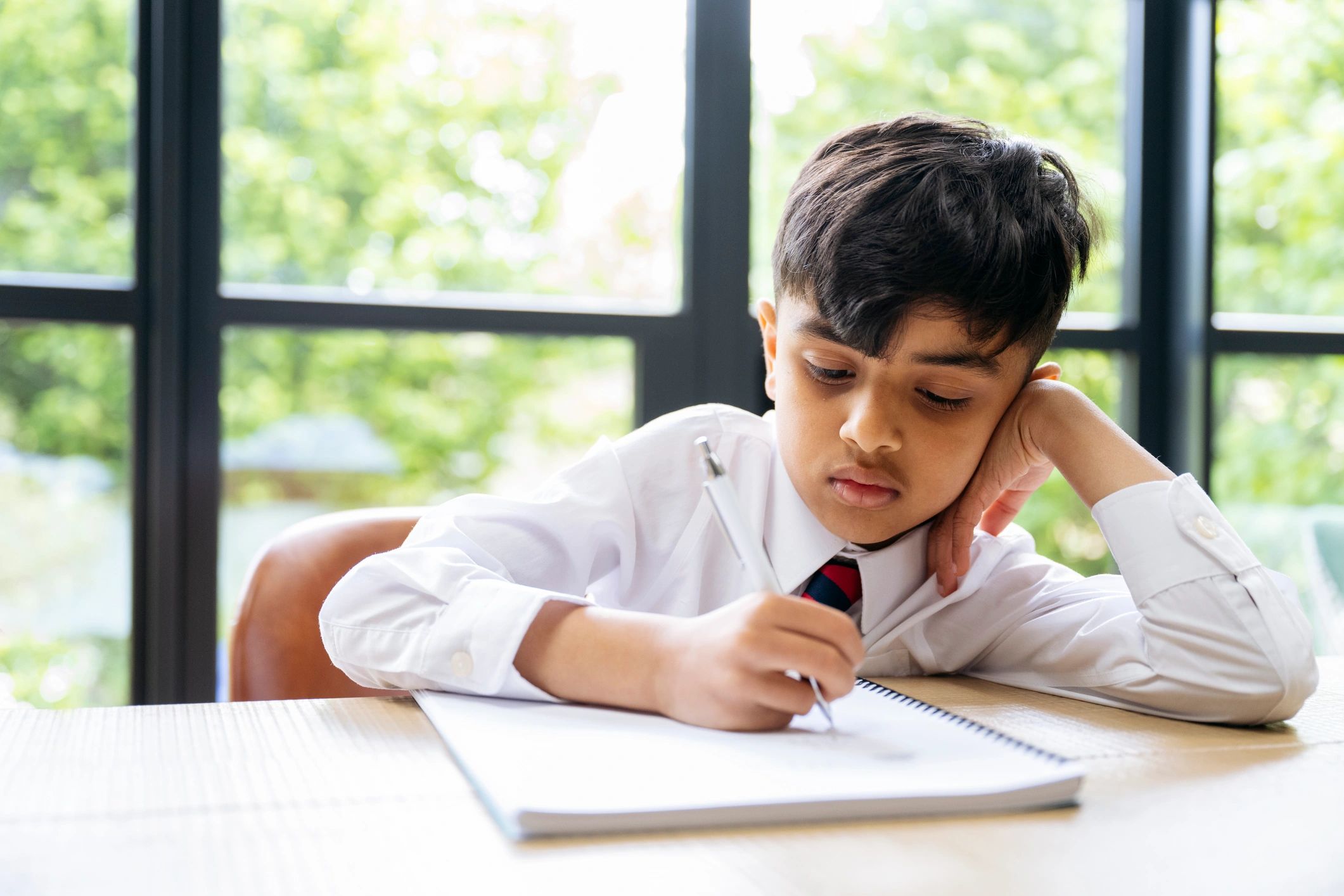 Student practicing handwriting in a notebook