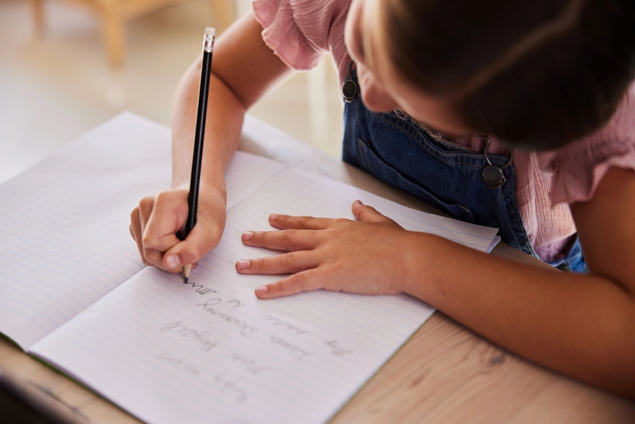 Young learner practicing handwriting in a workbook